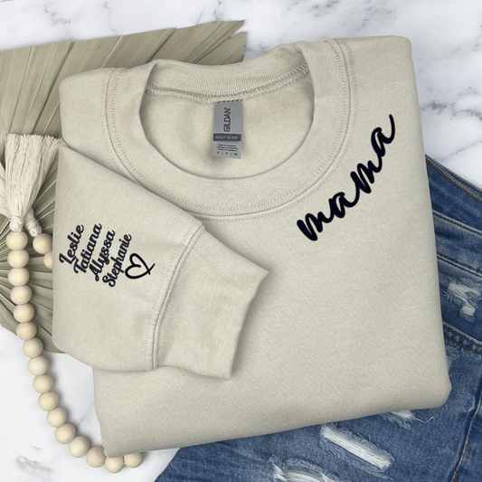 Sand Colored sweatshirt embroidered with the word mama around the collar. With kid's name embroidered on the sleeve with open heart underneath. Perfect Mothers day gift