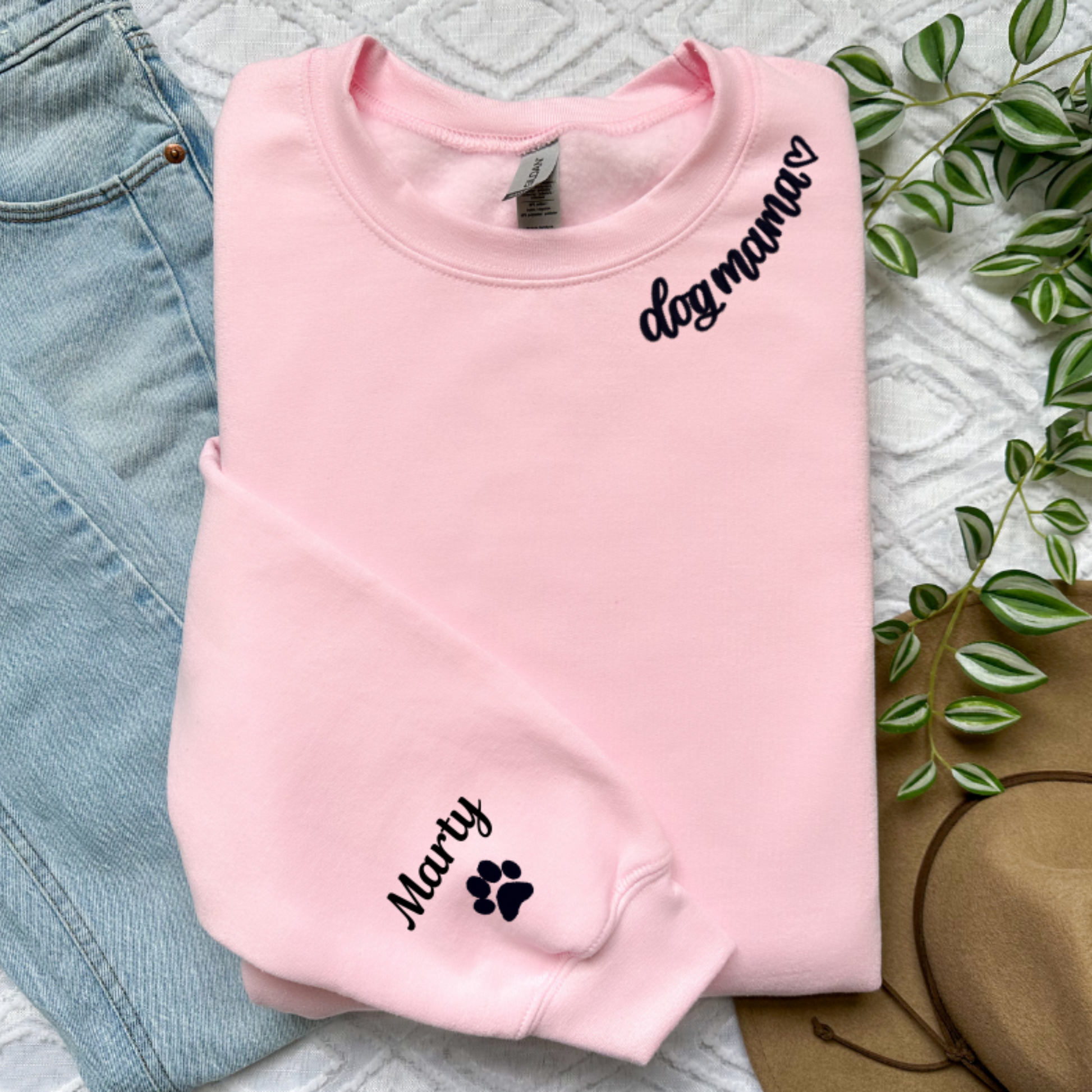 Pink sweatshirt with dog mama around collar and dog name on sleeve with a paw print