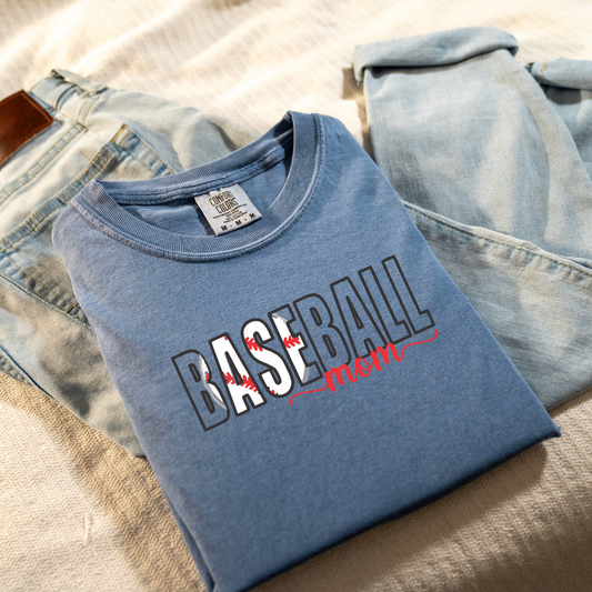 Solid blue shirt with Baseball Mama embroidered on it. The baseball is inside letters B, A,S,E the rest of the words are an outline. Mom is underneath in a cursive font