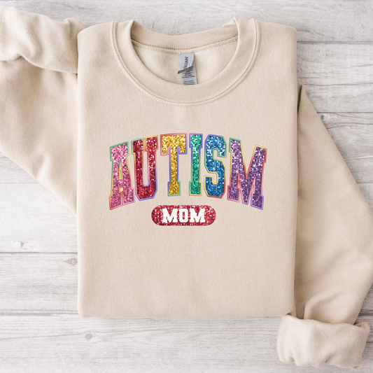 Sand colored sweatshirt with the word Autism mom printed on the front. Using faux sequins.